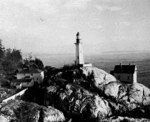 Historical photograph of the Light Tower at Point Atkinson, showing its compatibility with its wilderness seascape setting, 1925.; Parks Canada Agency / Agence Parcs Canada, 1925