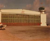 View of the west elevation of the Air Terminal Building (H-7), showing the six large panels of horizontally sliding glazed hangar doors.; Transport Canada / Transports Canada