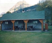 General view of Kitchen Shelter 1, showing the simple, low massing of the one-storey structure, 1990.; Parks Canada Agency / Agence Parcs Canada, 1990.
