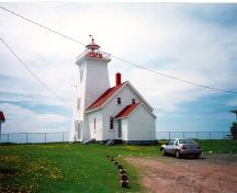 Rear view of the Tower and Fog Alarm at Wood Islands, showing the metal and glass lantern, the wood frame construction, and multi-pane wood sash windows, ca. 1990.; Department of Transport / Ministère des Transports, ca./vers 1990.