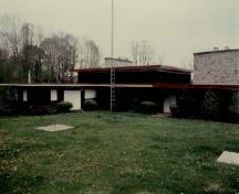 Vue de la façade générale de la villa, qui montre sa volumétrie horizontale, de plain-pied et la composition tripartite, 1989.; Environment Canada / Environnement Canada, 1989.