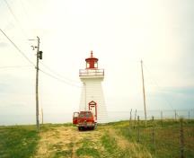 View of Point Bonaventure Light Tower, showing its tapered silhouette and octagonal lantern, 1992.; Agence Parcs Canada / Parks Canada Agency, 1992.