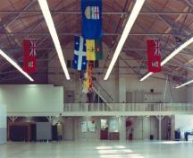 Interior view of the Armoury in Pembroke, showing its large, open drill hall with its exposed steel trusses, 1992.; Department of National Defence / Ministère de la Défense nationale, 1992.