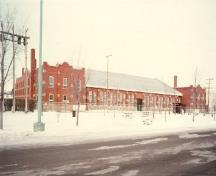 Rear view of the D.V. Currie VC Armoury, showing its economical, but high-quality design and construction, with careful attention to detailing and selection of materials, 1986.; Parks Canada Agency / Agence Parcs Canada, 1986.