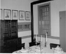 View of the interior of the Officers' Quarters, showing the dining room and office.; Agence Parcs Canada / Parks Canada Agency