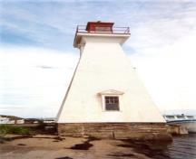 General view of the Mabou Lighthouse showing the west elevation of the tower and the sturdy, solid construction and durable materials including the wood frame, reinforced concrete foundation and clapboard siding, 2002.; Public Works Canada / Ministère des Travaux publics, 2002.