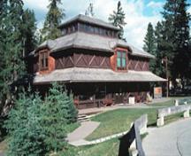 General view showing the stepped massing defined by the wide bracketed veranda, hipped roof form of the main block, and the lantern set at the top of the roof.; Parks Canada
