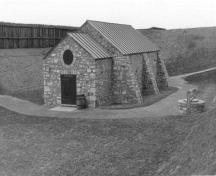 General view of the Powder Magazine, showing the sturdy thick-walled masonry construction, which is typical of the work of the Corps of Royal Engineers, 1989.; Parks Canada Agency / Agence Parcs Canada, 1989.