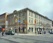 Corner view of the Former Geological Survey of Canada Building showing the hipped, low-pitched metal clad roof on the Sussex Drive section and the gable roof on the George street wing, 2011.; Parks Canada Agency / Agence Parcs Canada, M. Therrien, 2011.