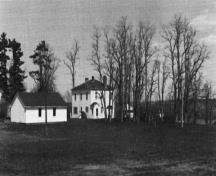 This image shows a historic lateral view of the building; Queens County Museum Collection