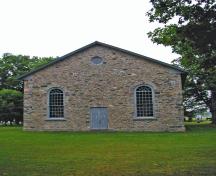 General view of Old Stone Church, showing its end-gable entrance with a central door flanked by two large multi-pane windows, 2006.; Parks Canada Agency / Agence Parcs Canada.