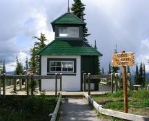 Front view of the building, from the west, showing exterior covering of wooden shingles and clapboard, surmounted by a smaller square cupola, with windows.; Parks Canada Agency/Agence Parcs Canada , 2011