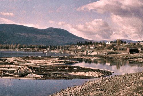 view from south of Nakusp waterfront with log boom, 1950s