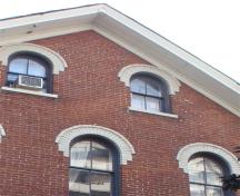 Detail of front facade window, brick, and gable.; RHI2, 2009