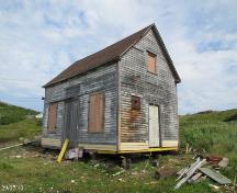 View of the front and right facades of Ashbourne's Lower Trade General Store, Twillingate, NL. Photo taken 2010. ; © Isles Wooden Boat Building Committee 2010
