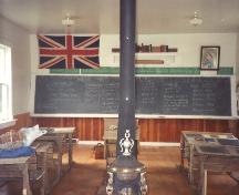 Showing central stove, desks, flag, etc.; Friends of Lucy Maud Montgomery School, Lower Bedeque, 2004