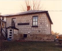 Vue générale de la façade est de la maison fortifiée du maître-éclusier, 1987.; Parks Canada Agency / Agence Parcs Canada, 1987.