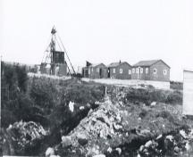 Iron Springs Mine Heritage Site showing the mine buildings and the shaft, also included is the building used as the temporary first aid center for the survivors of the Truxtun and Pollux ship wrecks. Photo ca 1942.; Ena Farrell Edwards 2005.