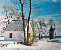 Side view of Île Perrot Windmill and Miller's House, showing the rectangular footprint of the house with its one-and-a-half storey massing, 1995.; Parks Canada Agency / Agence Parcs Canada, 1995.