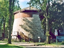 General view of Québec Martello Towers, showing their squat, cylindrical, two-storey massing with slightly inclining exterior walls, 2003.; Parks Canada Agency / Agence Parcs Canada, 2003.