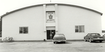 Vue générale du hangar 3, montrant l'entrée centrale et le toit bas en arc, 1987.; Department of National Defence / ministère de la Défense nationale, 1987.