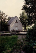 Façade of the French People's House, showing its storey-and-a-half massing, built close to the ground, with few window openings, 1991.; Parks Canada Agency / Agence Parcs Canada, Christine Chartré, 1991.