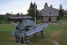 General view of St. Andrews Blockhouse, appearing in the background, 1987.; Parks Canada | Parcs Canada, 1987.