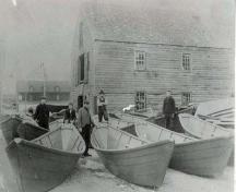 Workers posing with new dories outside of the Dory Shop, Shelburne, NS, ca. 1890.; Courtesy of the Shelburne County Museum.