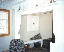 Interior view of central fireplace showing seating area, White House, Portugal Cove/ St. Philips, NL.; HFNL 2006
