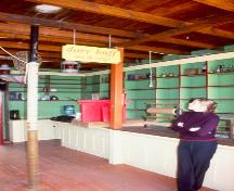 Interior photo of Kean's General Store, Brookfield, Newfoundland, showing Janet Davis, proprietor of the Norton's Cove Studio, which operates out of the building.; HFNL 2006