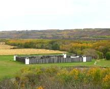 View northwest at the reconstructed fort in its valley setting, 2004.; Government of Saskatchewan, Marvin Thomas, 2004.