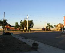View south at station, caboose and house on heritage park site at end of Main Street, 2005.; Government of Saskatchewan, Marvin Thomas, 2005.