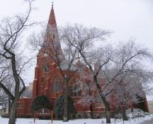 View of the front and side of St. John's Anglican Cathedral highlighting the tall spire, 2006.; Government of Saskatchewan, Bernie Flaman, 2006.
