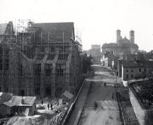 View of Cathedral Street with the building of the Anglican Cathedral on the left, with the Benevolet Irish Society building and the Roman Catholic Basilica in the background. Photo pre-1892. ; Centre for Newfoundland Studies photo 2.02.001. Photographer: S.H. Parsons