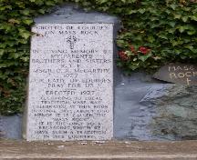 Memorial plaque and section of Mass Rock at the Grotto of Our Lady of Lourdes, Renews, NL. Photo taken December, 2005.; HFNL/Andrea O'Brien 2005
