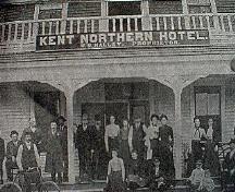 People gathered on the steps of the Kent Northern Hotel.; Village of Rexton