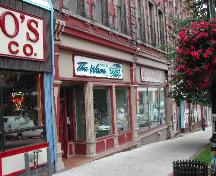 This photograph shows the storefront cornice, large plate glass windows and columns, 2004; City of Saint John