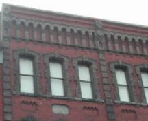 This photograph shows the roof-line cornice and also illustrates the sandstone block with the name Doherty engraved, 2005; City of Saint John
