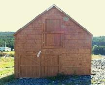 Exterior view of Burgess Stage, Whiteway, Trinity Bay, NL showing the upper loft door and lower double door.  Photo taken September 8, 2005.; HFNL 2005