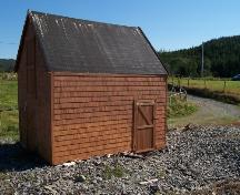 View of ocean-facing side of Burgess Fishing Property showing access door on front, the loft and double barn doors are on the left facade.  Photo taken September 8, 2005.; HFNL 2005