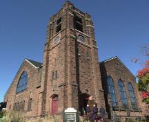 The square bell tower of First Moncton United Baptist Church is one of the striking features of this brown sandstone structure.; First Moncton United Baptist Church