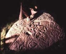 Petroglyphs show prominently under oblique lighting, 1988.; Government of Saskatchewan, 1988.