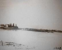 Burns Mill with a large sawdust pile and boat.; Village of Rexton