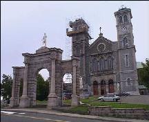 Westward view of the Basilica Entrance Archway, showing the Basilica of St. John the Baptist in the background,; HFNL 2006.