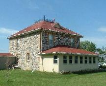 Front facade of the farmhouse on the Normand Homestead featuring the fieldstone walls, 2004.; Government of Saskatchewan, Lisa Dale-Burnett, 2004.