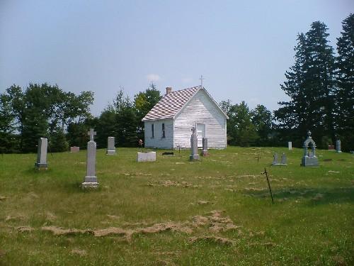 Front facade of church and cemetery markers