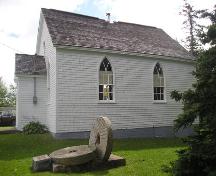 West elevation with mills stones in the foreground, Cole Harbour Meeting House, Cole Harbour, NS, 2005.; Heritage Division, NS Dept. of Tourism, Culture and Heritage, 2005.