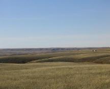 Stone features are situated on level ground on projecting fingers of land in near- and middle-ground, 2004.; Government of Saskatchewan, Marvin Thomas, 2004.