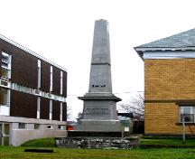 View of the front/east side of the Hamilton Monument, showing the monument in its surroundings, Library to the left, Court to the right.; Restigouche Regional Museum, Dalhousie