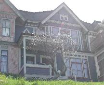 This photograph shows the complete façade of the building and its quaint setting upon a terrace overlooking Saint John Harbour, 2005; City of Saint John